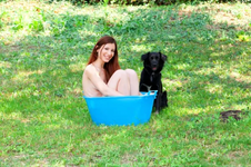 naked-woman-smiling-garden-bucket-blue-black-dog-9533855.jpg.png